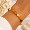Bracelet extensible en ambre naturel de la mer Baltique et perles dorées